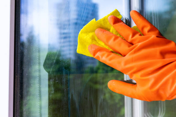 istock A worker washes the window with a yellow cloth. Cleaning service, works 1333069287