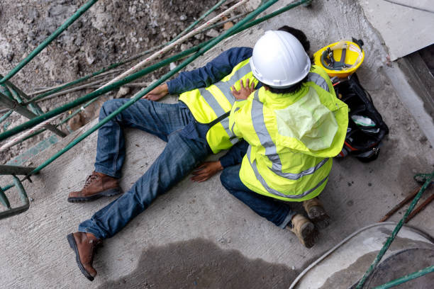 First aid support accident at work of construction worker at site. Builder accident falls scaffolding on floor stock photo