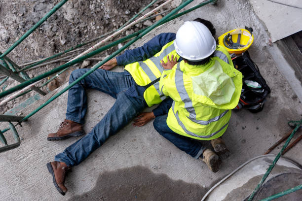 First aid support accident at work of construction worker at site. Builder accident falls scaffolding on floor First aid support accident at work of construction worker at site. Builder accident falls scaffolding on floor, Safety team helps employee accident. dead stock pictures, royalty-free photos & images