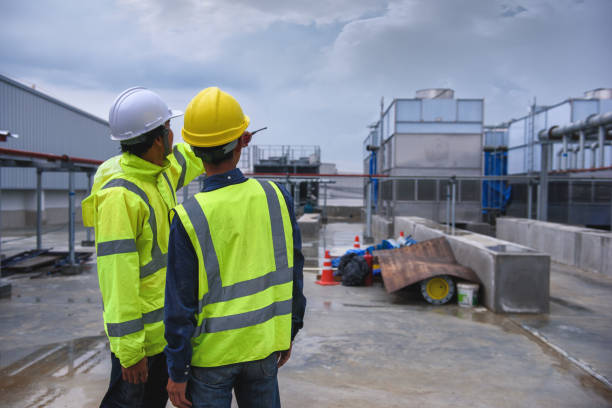 istock Two engineers wearing yellow mesh reflective safety vest discussed at the construction site and Pointing to the job 1333069433