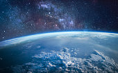 istock Earth planet surface in outer space. Stars and milky way on background. Sci-fi space wallpaper. Elements of this image furnished by NASA 1333071678