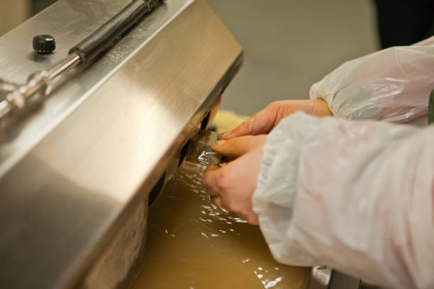 istock Laboratory worker polishing boulder precious stone. worker hands, no face, unrecognizable person. worker cutting a stone 1333073647