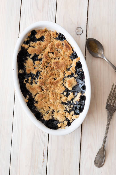 istock Blueberry crumble pie in oval white cooking pan with old silverware 1333076536