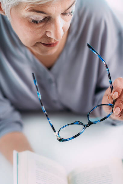 istock Senior Woman With Eyeglasses Having Problems with Book Reading. Indication for Cataract, Glaucoma, and Vision Loss in the Elderly. 1333076700