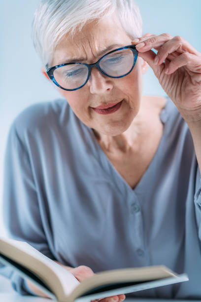 istock Glaucoma. Senior Woman a Reading Book, Having Ocular Tension. 1333076758