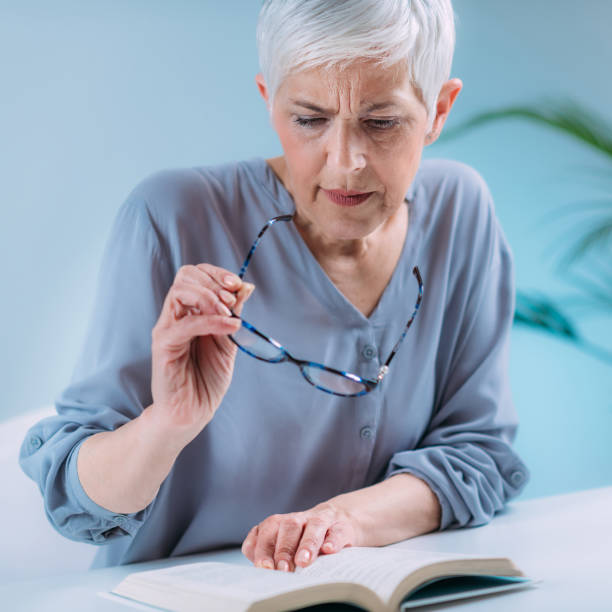 istock Senior Woman a Reading Book. Vision Loss Problems. 1333076776