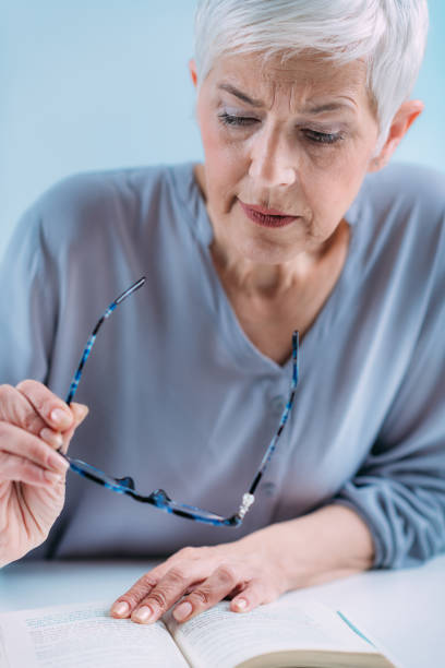istock Senior Woman a Reading Book. Vision Loss Problems. 1333076803