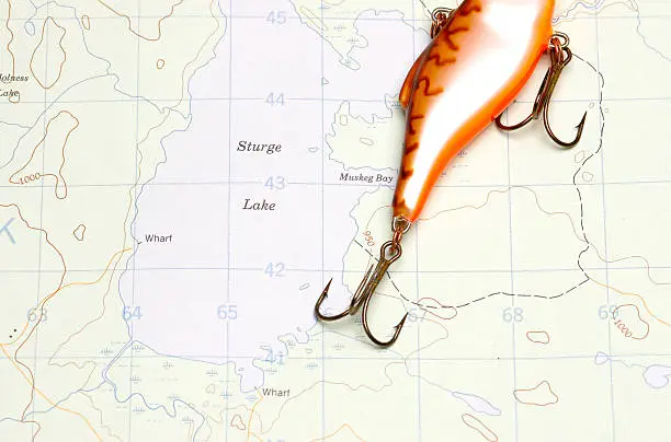 fishing lure on a forestry map showing lakes and mountain elevations.