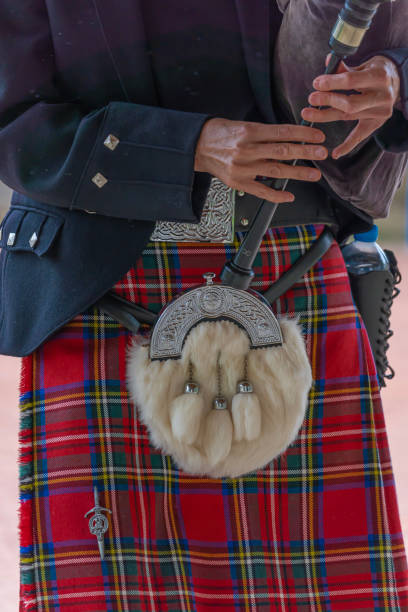 Langrune-Sur-Mer, France: Auld Alliance Pipe Band Langrune-Sur-Mer, France - 08 05 2021: Auld Alliance Pipe Band: Detail of the costume and instrument of a bagpiper tank musician stock pictures, royalty-free photos & images