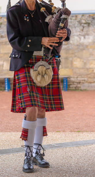 Langrune-Sur-Mer, France: Auld Alliance Pipe Band Langrune-Sur-Mer, France - 08 05 2021: Auld Alliance Pipe Band: Detail of the costume and instrument of a bagpiper tank musician stock pictures, royalty-free photos & images