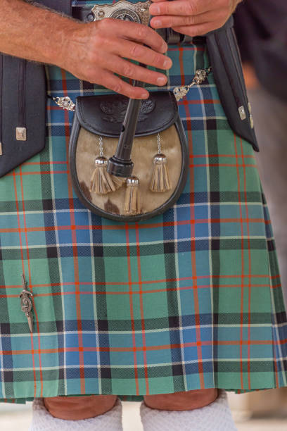 Langrune-Sur-Mer, France: Auld Alliance Pipe Band Langrune-Sur-Mer, France - 08 05 2021: Auld Alliance Pipe Band: Detail of the costume and instrument of a bagpiper tank musician stock pictures, royalty-free photos & images