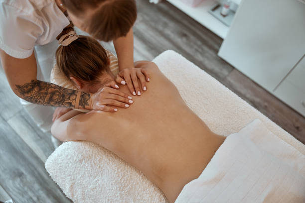 istock Professional confident massage master is doing procedures to caucasian woman in minimalistic modern cabinet 1333080074