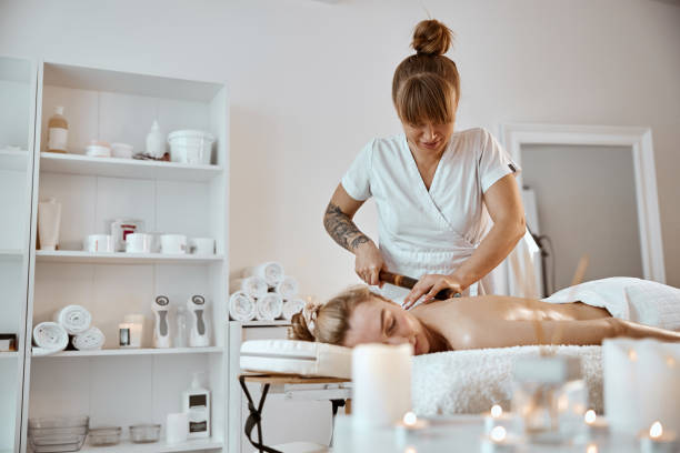 istock Professional confident massage master is doing procedures to caucasian woman in minimalistic modern cabinet 1333080101