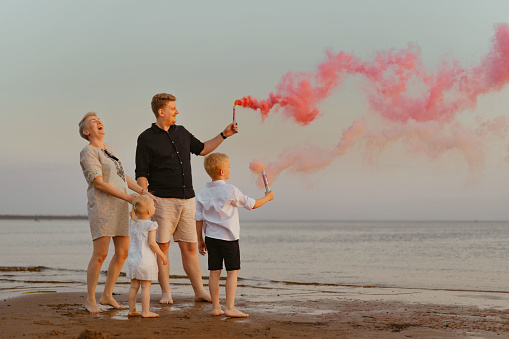 Gender reveal announcement on the beach. Loving family expecting baby girl. Happy moments. High quality photo