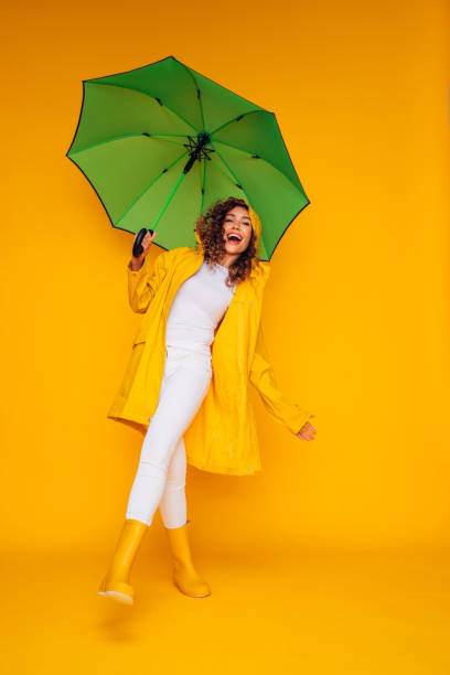 istock Girl with green umbrella 1333082028