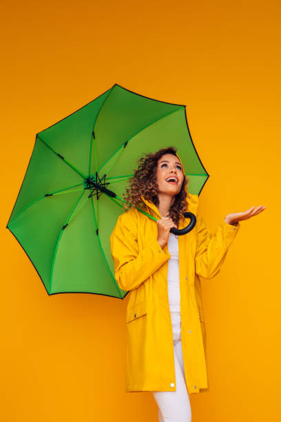 istock Girl with green umbrella 1333082049