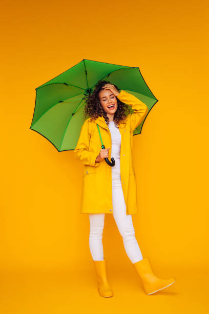 istock Girl with green umbrella 1333082058