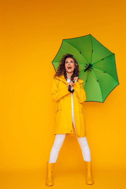 istock Girl with green umbrella 1333082068