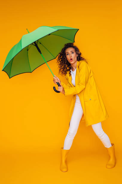 istock Girl with green umbrella 1333082080