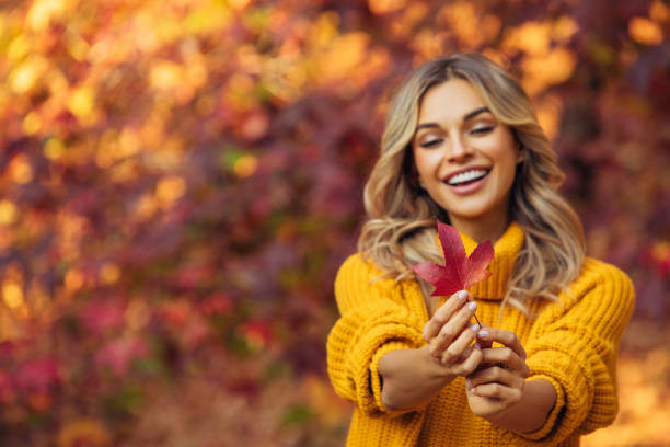 istock Beautiful woman holding a leaf 1333082721