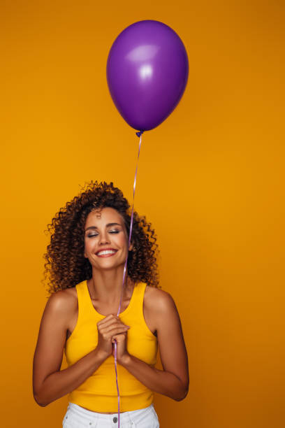 istock Beautiful woman holding a balloon 1333083109