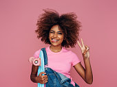 Photo of young curly girl with skateboard
