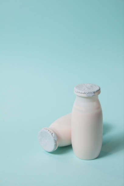 istock Bottles with probiotics and prebiotics dairy drink on light blue background. 1333084926