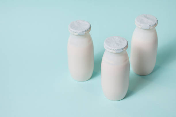 istock Bottles with probiotics and prebiotics dairy drink on light blue background. 1333084959