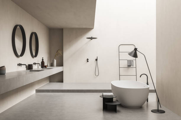 istock Beige bathroom with bathtub, lamp and accent round mirrors 1333086946