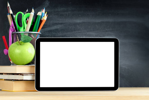 istock pencil holder, books, apple and digital tablet 1333087119