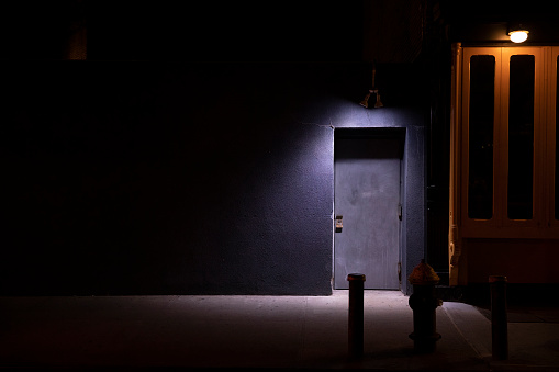 Dramatic lighting to door at night in New York City.