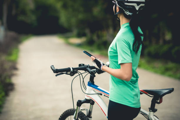 istock Cyclist use smartphone for navigation when riding mountain bike on forest trail 1333088900