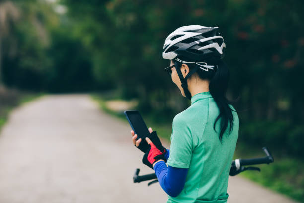 istock Cyclist use smartphone for navigation when riding mountain bike on forest trail 1333088940
