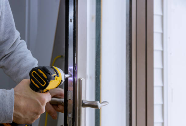 istock Locksmith hand holds the screwdriver in installing new house door lock 1333089078