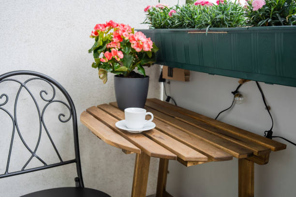 istock Wooden table with cup of coffee at balcony 1333090540