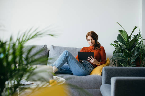 istock Beautiful Woman Using Digital Tablet at Home 1333092712