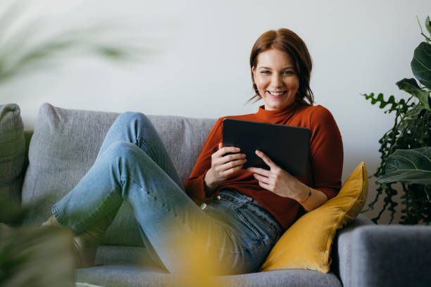 istock Smiling Woman Using Digital Tablet at Home 1333092718