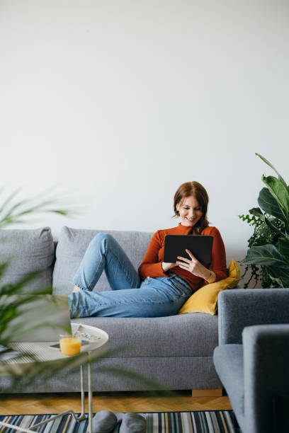 istock Happy Woman Using Digital Tablet at Home 1333092721