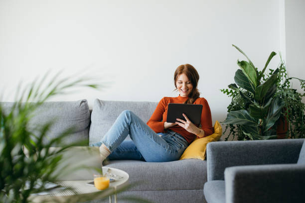 istock Cheerful Woman Using Digital Tablet at Home 1333092729