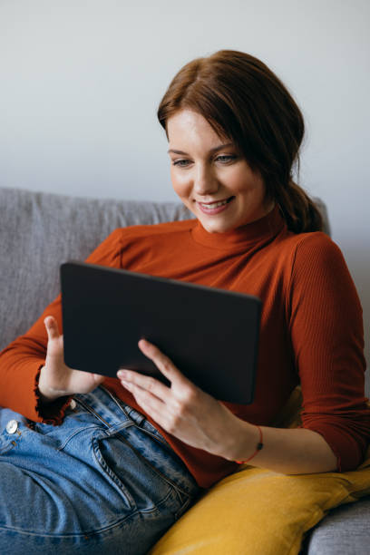 istock Smiling Woman Using Digital Tablet at Home 1333092732