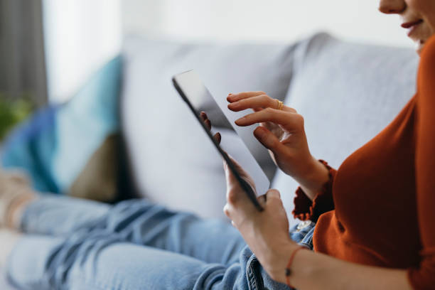 istock An Anonymous Woman Using Digital Tablet at Home 1333092736