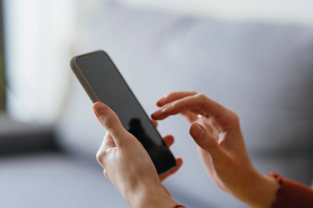 An Anonymous Woman Using Mobile Phone at Home