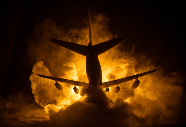 istock Air Crash. Burning falling plane. The plane crashed to the ground. Decorated with toy at dark fire background. Air accident concept. 1333096310