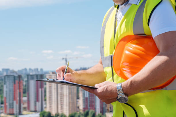istock Hands of mature man at construction site write notes on clipboard close-up 1333096451