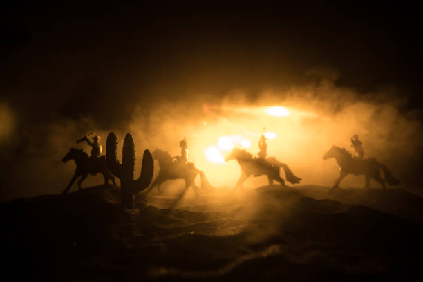 istock Western cowboy silhouette with texture at sunset and slivers of light 1333099383