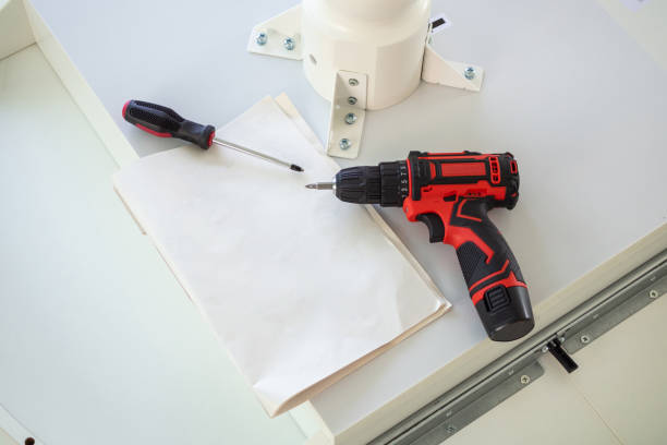 istock Cordless screwdriver on wood table assembly furniture concept 1333101006