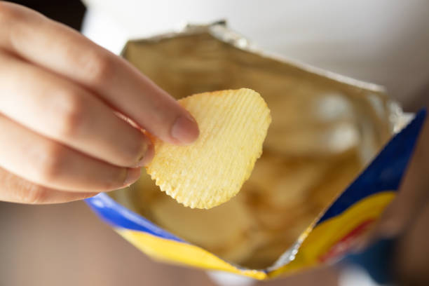istock Hand hold potato chips with snack bag 1333101049