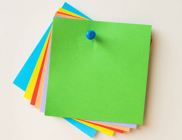 istock Colorful Paper Notes Stacked Together And Pinned On The Wall. Different Colored Sheets Of Note Attached On A Plain Wallpaper With A Pin. 1333101832