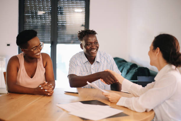 istock Young couple making an agreement with the real estate agent 1333102977