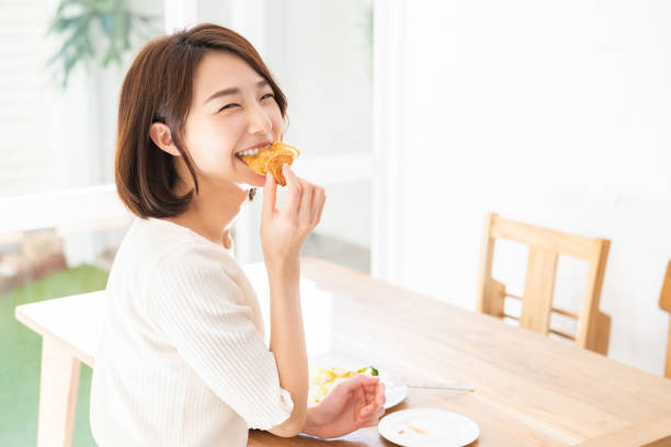 istock attractive asian woman who eats 1333104496